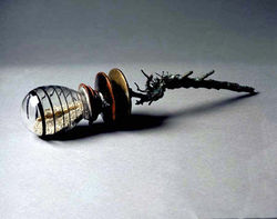 Mesquito-1997  cast bronze mesquite root, cast bronze disk, apple wood disk, blown glass, 
