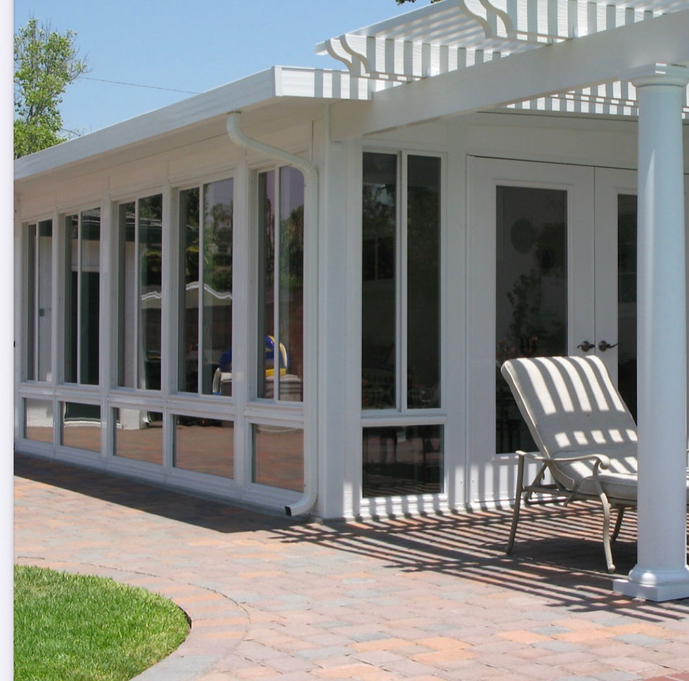 Four Season sunroom with white pergola and patio
