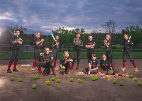 High dynamic range dramatic image of a girls, youth softball team taken under a vibrant sky and using off camera flash and blending 11 different photos. 