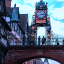 Photograph of the iconic Eastgate Clock in Chester, viewed from below the bridge archway with Tudor-style buildings on the left.
