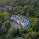 Aerial drone photograph of the historic Reader Mansion House, a Liverpool wedding venue, nestled in the lush greenery of Calderstones Park.