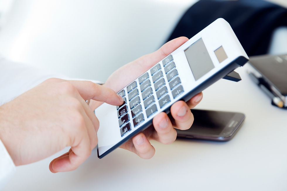 A person calculates numbers, focused on financial details of a cleaning service