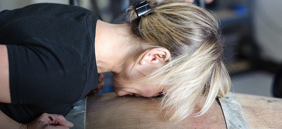 Winemaker Brianne Day sticks her nose deep into a wine barrel.