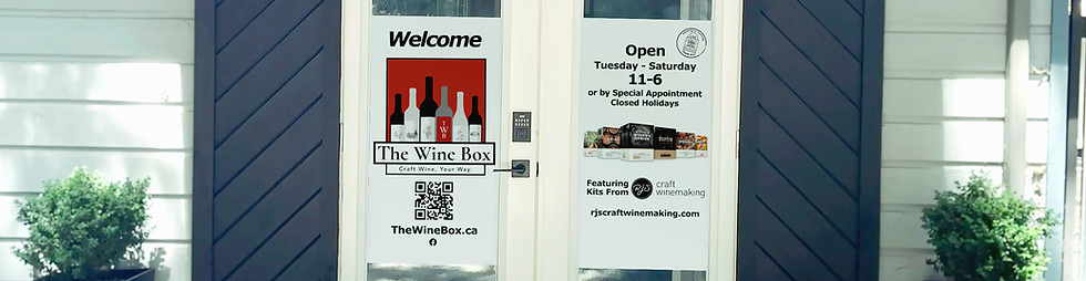 An image of the entrance doors to The Wine Box Winemaking Boutique on a sunny day.