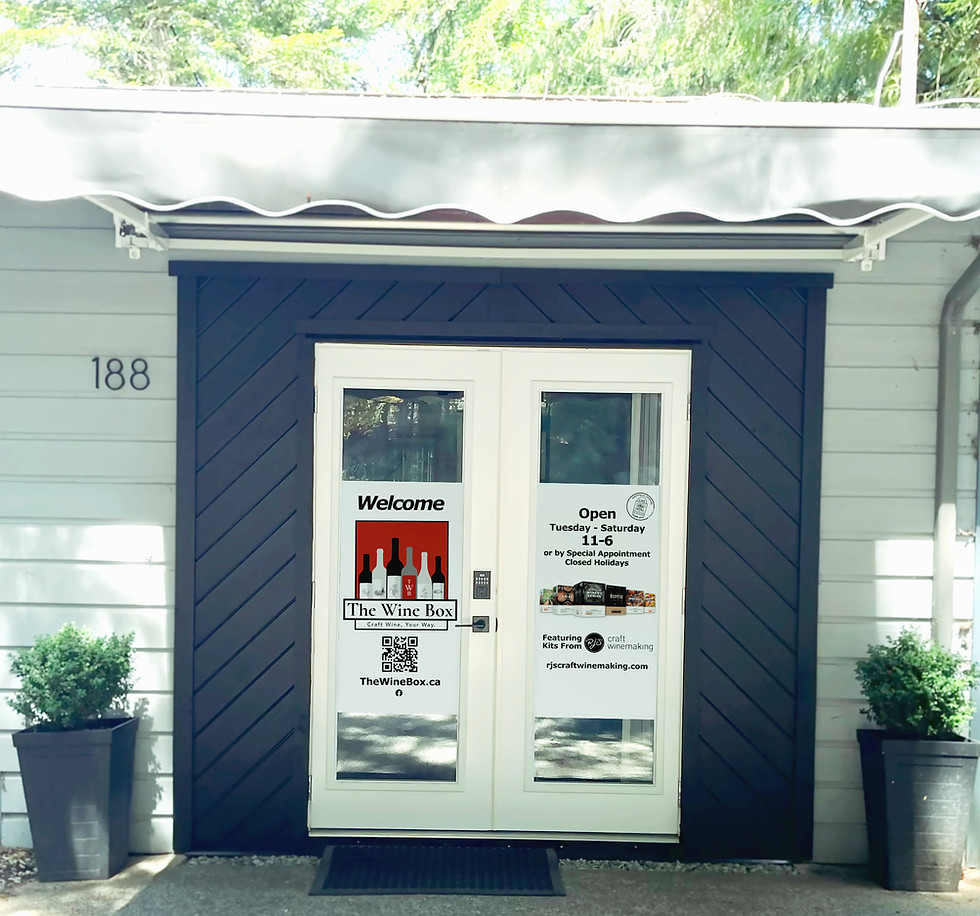 An image of the entrance doors to The Wine Box Winemaking Boutique on a sunny day.