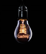 Hanging lightbulb with glowing Coaching