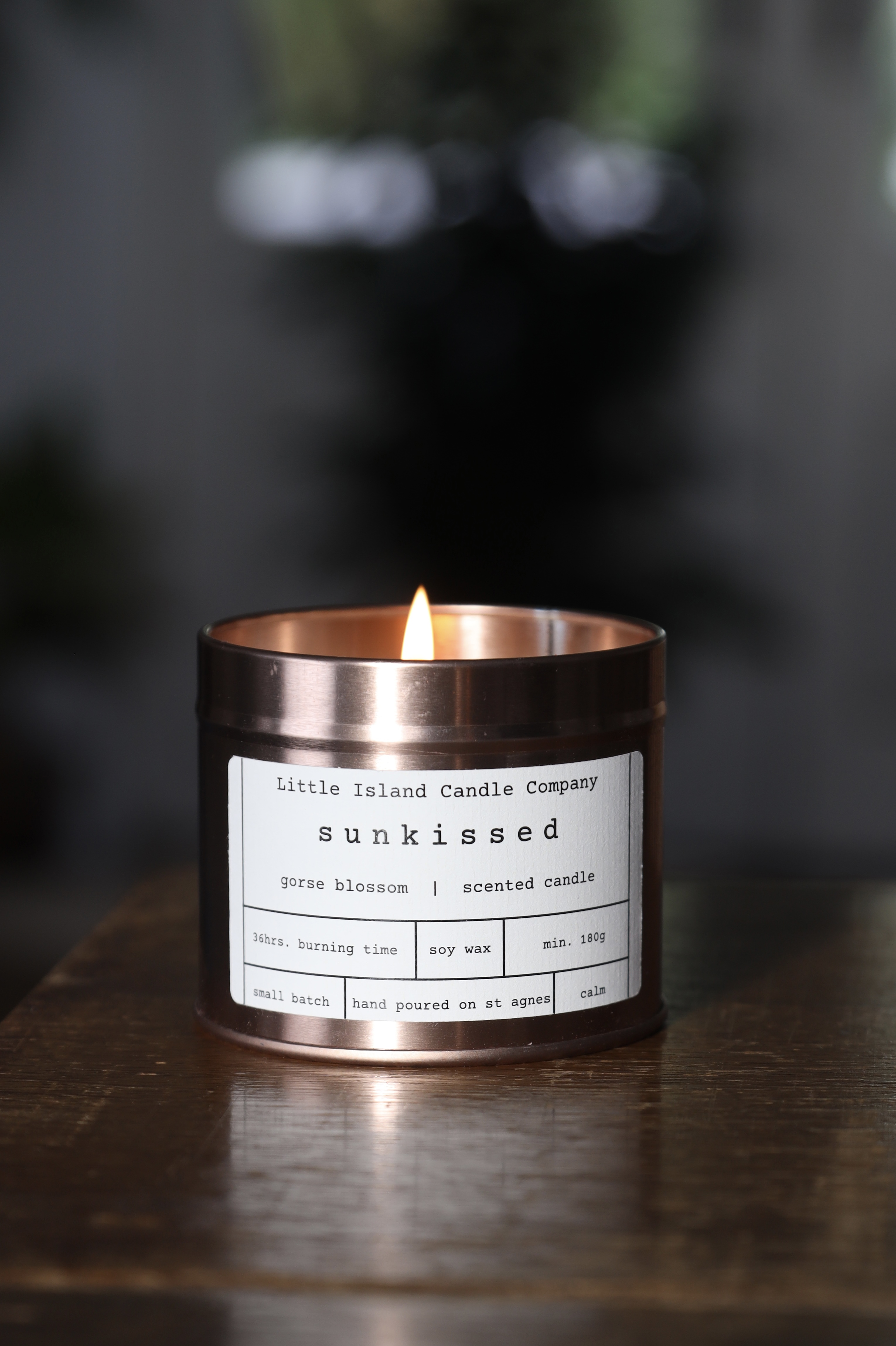 Sunkissed candle, lit, in a rose gold tin