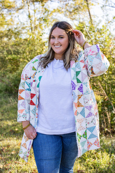 A woman in a quilt jacket with a triangular geometric pattern.