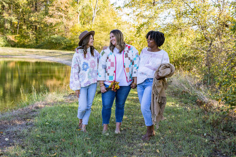 A group of three women wearing quilt jackets.