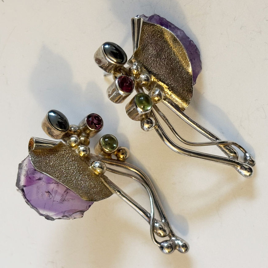 Sterling silver artisan earrings featuring rough amethyst slices accented with garnet, peridot and hematite gemstones.