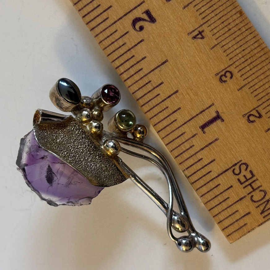 Sterling silver artisan earrings featuring rough amethyst slices accented with garnet, peridot and hematite gemstones.