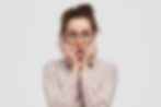 unhappy-nervous-young-female-with-worried-expression-bites-finger-nails-looks-anxiously-di