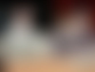 Brothers Nick and Shane Sullivan, of Joyer, sit in a booth at a dimly-lit restaurant. A tray with pizza sits in front of them. 