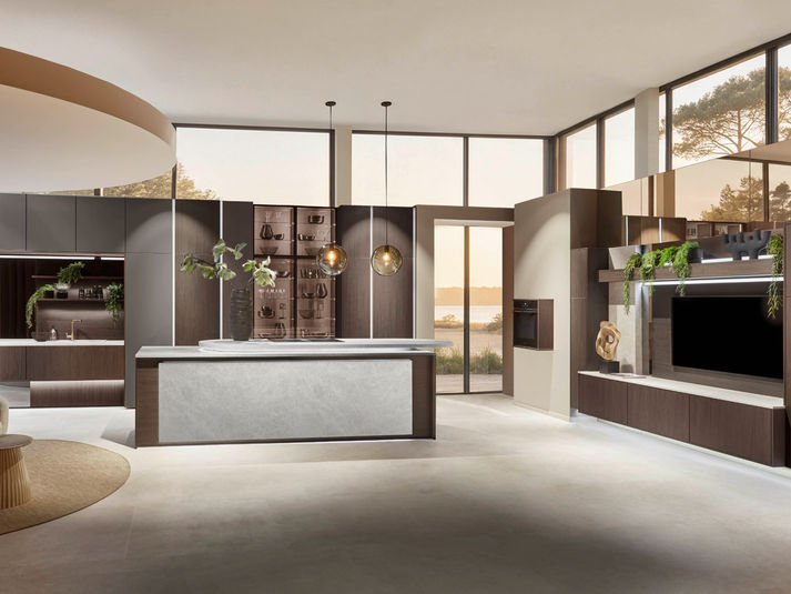 Dark wood-effect kitchen with a central island in a bright, open-plan living space.