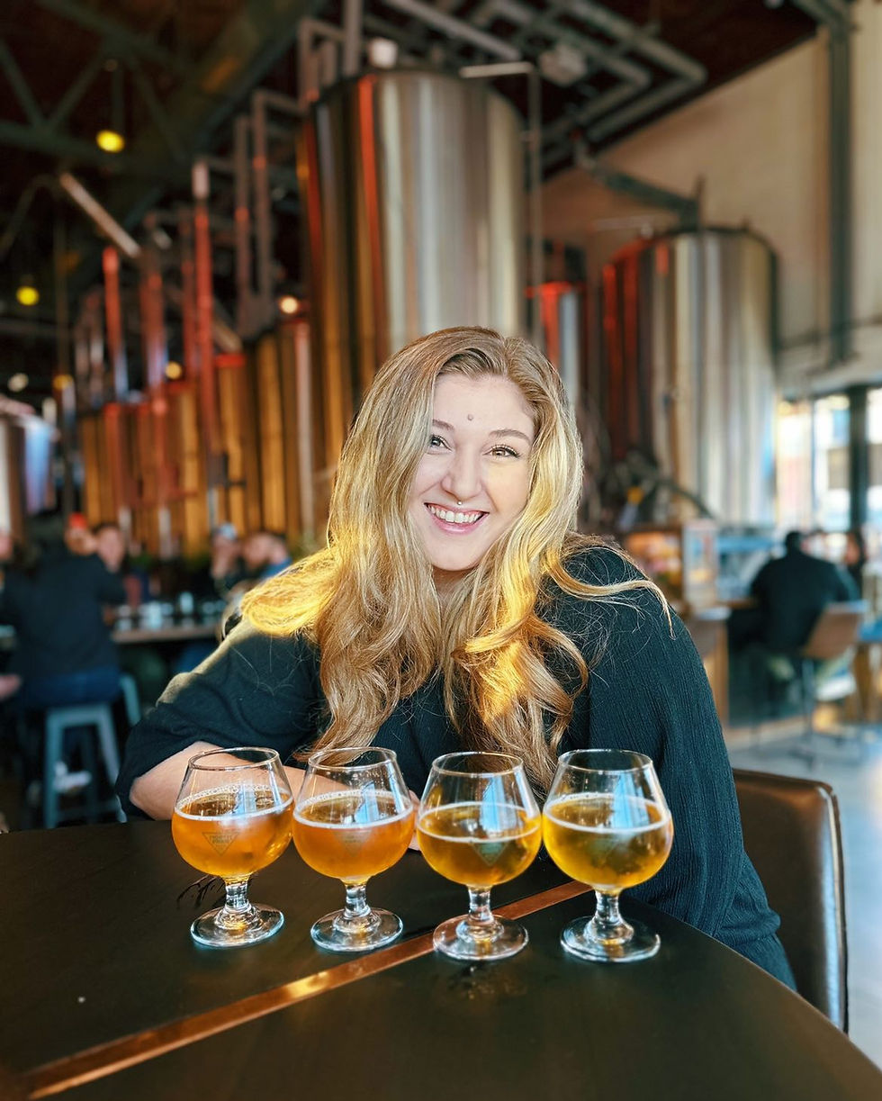 Girl with craft beers for tasting in brewery in San Diego, California
