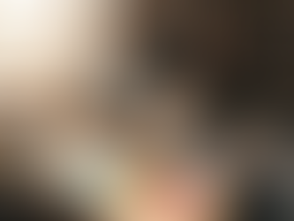 Artist pouring resin in cluttered studio