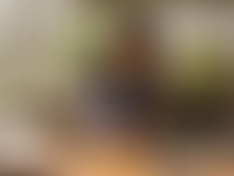 Craftsperson pouring epoxy resin onto wooden tray