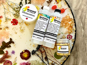 Artist pouring resin onto canvas in studio