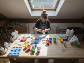 Artist preparing resin casting supplies in studio