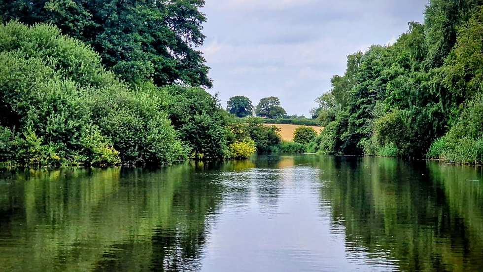 Panoramic view of the Norfolk Broads with open water, reedbeds and traditional Broads landscape under a wide Norfolk sk