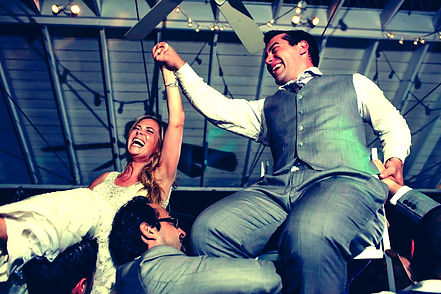 Bride & Groom lifted on chairs