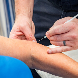 an expert offering injection therapy for tennis elbow