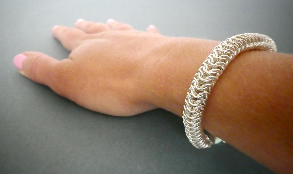 Thumbnail: chain maille round weave sterling silver bracelet on womans wrist