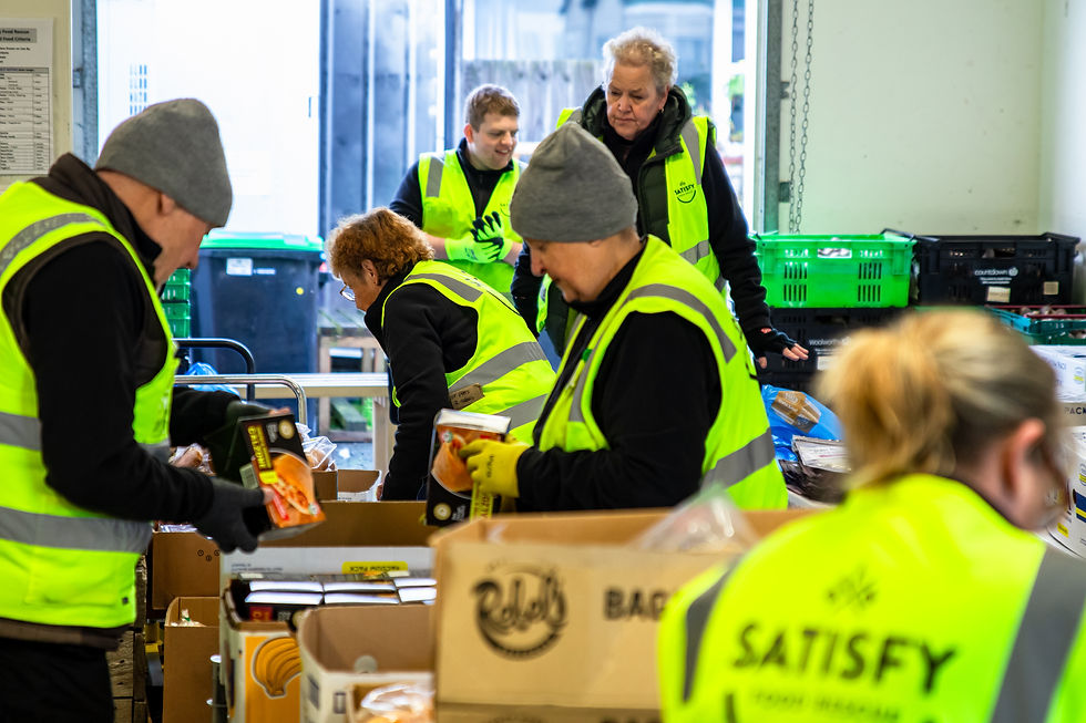 Our amazing volunteers working hard to organise and pack rescued food at our busy warehouse.