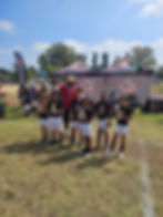 Eye-level view of a football field with goalposts and bright blue sky