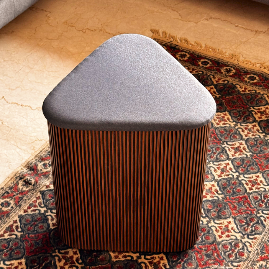 Triangular Luxury Ottoman with unique fluted finish and upholstery.