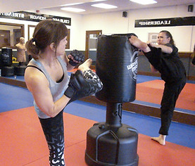 students kicking a tall bag