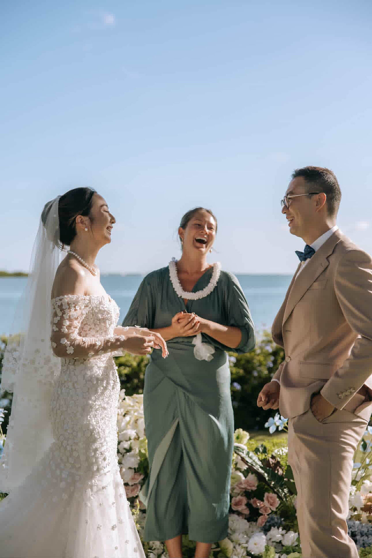 Couple laughs at officiants speech during their oahu hawaii ceremony