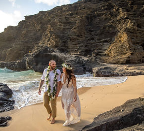 couple walks down the beach after their elopement with Oahu Officiant in Hawaii