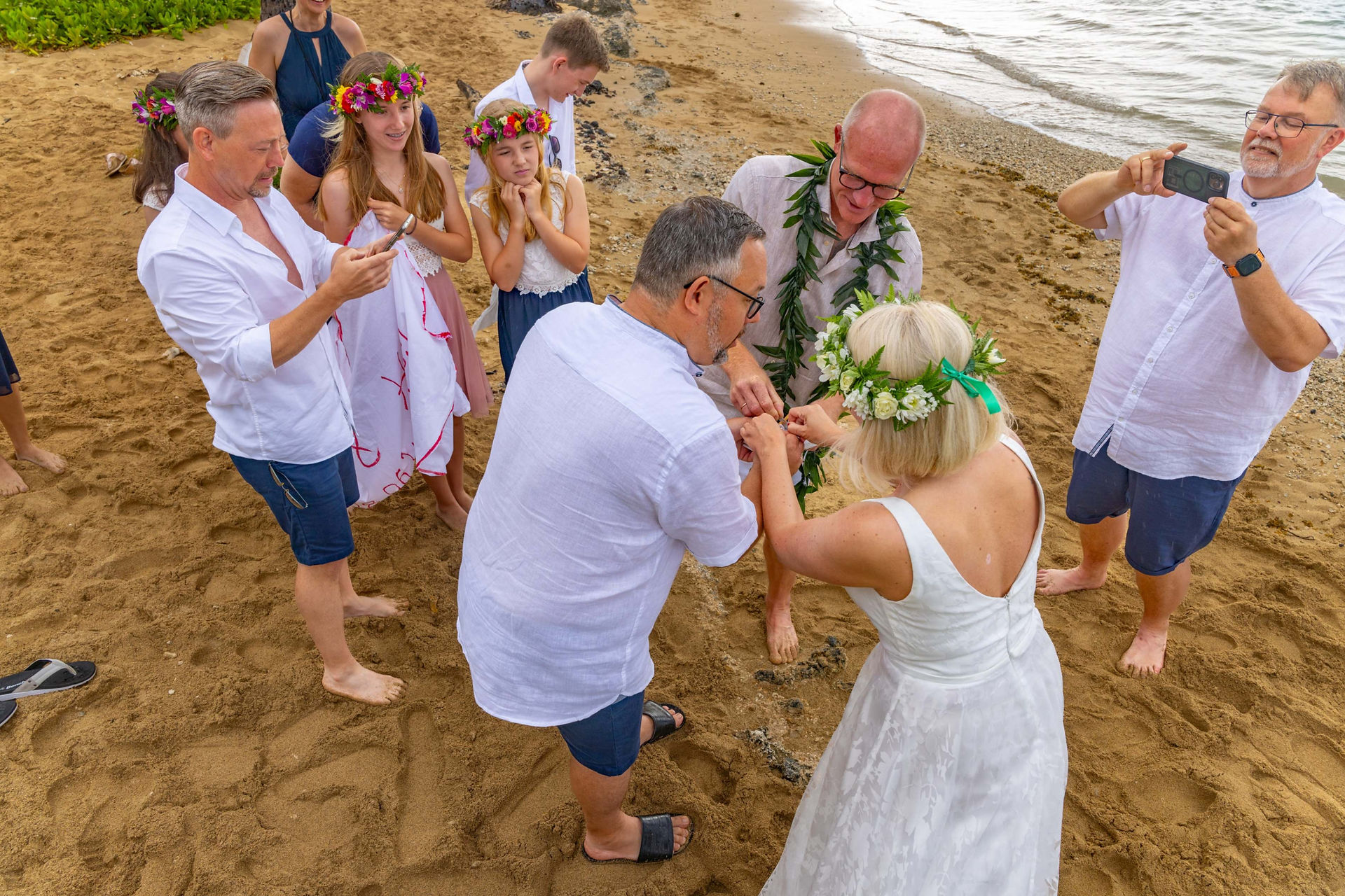 German couple has a wedding in Oahu Hawaii in which they perform the Baumstamm Sägen german wedding tradition with Nicole Van Diver their wedding Officiant 