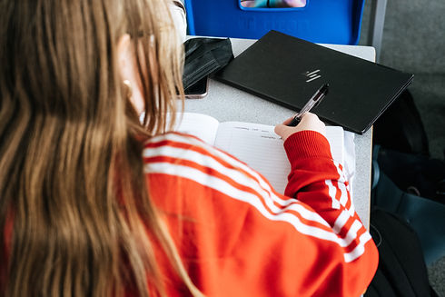 top view of a student writing in a notebook