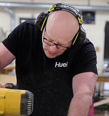 design and technology teacher using rotary saw