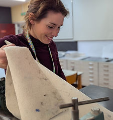 head of creative arts lifting blankets from printing press
