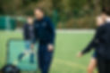 PE coach with students for hockey practice