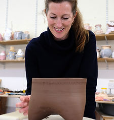 photographic portrait of ceramics teacher making a pot