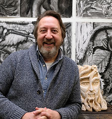 art teacher in front of student artwork