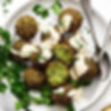 Falafel is usually served with bread or salad and topped with tahini or other sauces.