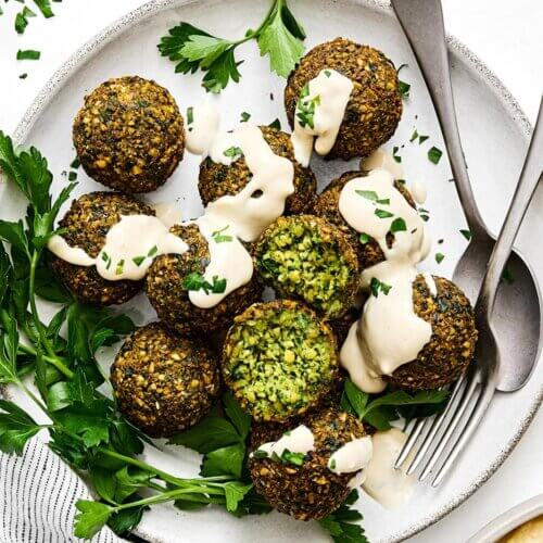 Falafel is usually served with bread or salad and topped with tahini or other sauces.