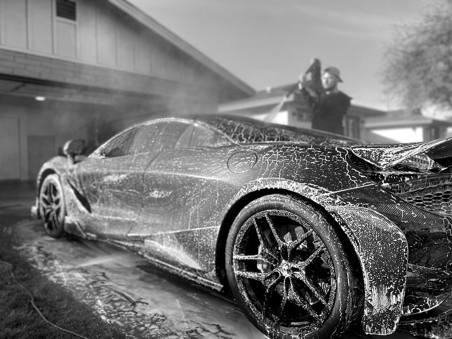 Mobile detailing near me service washing a supercar in a driveway