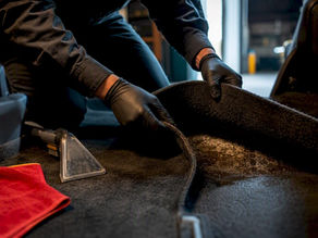 Technician inspecting gasoline-contaminated vehicle carpet