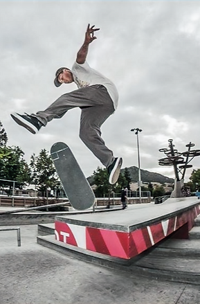 Skateboarder kickflip off of drop at San Luis Obispo skatepark