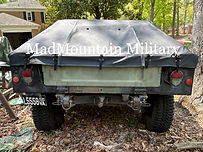 Camoflage M998 Humvee with black sailcloth soft slant back shown from rear