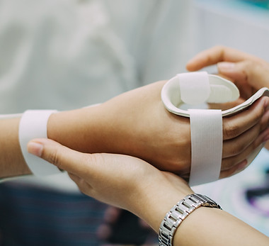 Therapist making asissistive device for immobilize patient hand Splint service for hand in