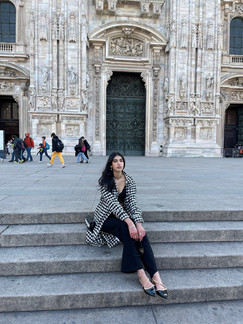 Acela ' Ace ' Kandola sitting on the steps in front of the Milan Cathedral, Duomo