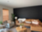 Living room with dark painted accent wall and light walls