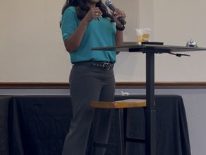 Lee Caldwell speaking to a group of business professionals during a live educational presentation.